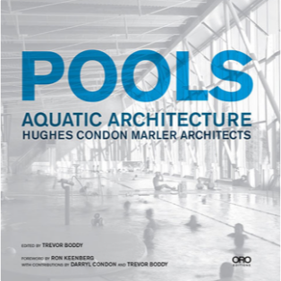 The front cover of "POOLS: Aquatic Architecture", which has a black and white photo of an indoor pool behind it.