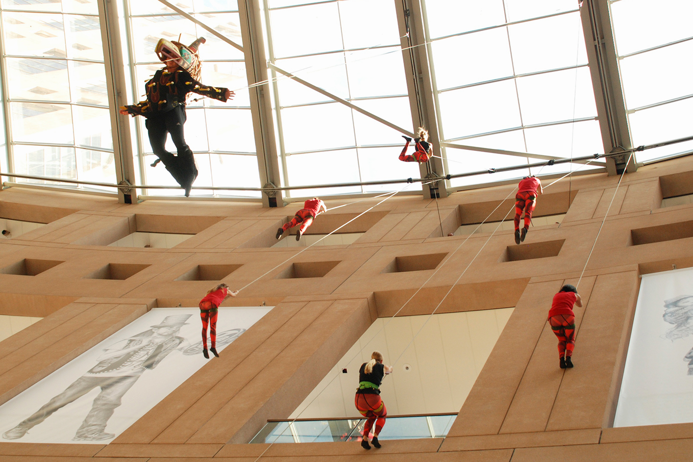 Julia Taffe's Aeriosa dancers suspended from the ceiling of the Main Branch of the Vancouver Public Library.
