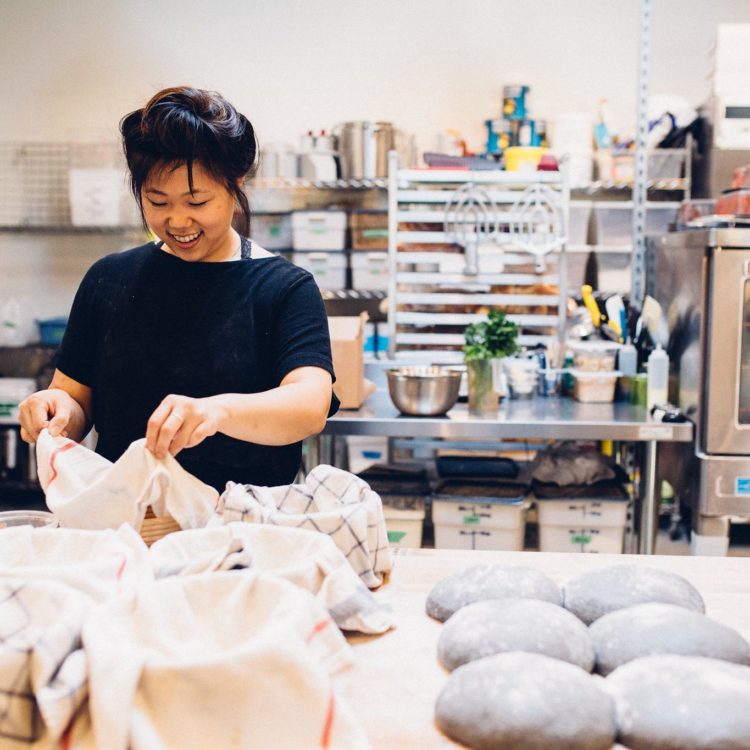 Annabell Choi making sourdough bread in a commercial kitchen.