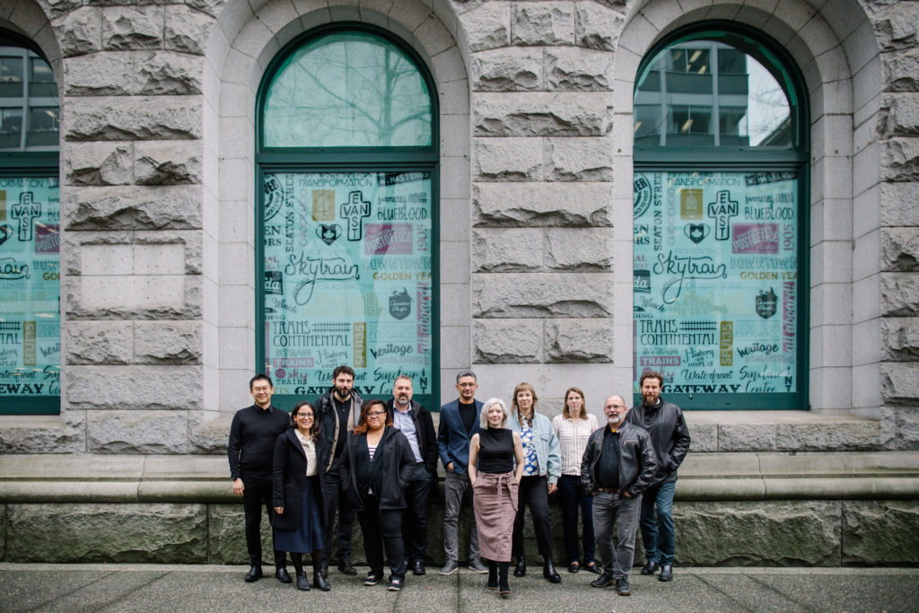 Group of hcma practitioners standing in front of a building.