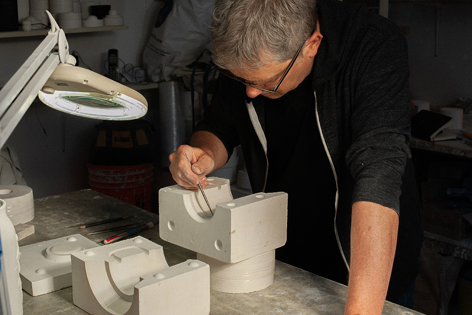 Russell Hackney working on the master mould for the hcma ceramic mug.
