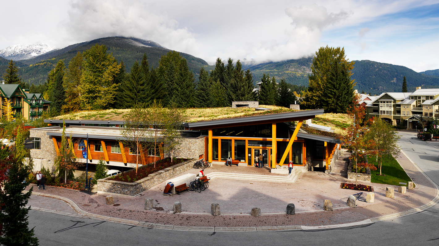 Outside view of Whistler Public Library, which uses wood beams and a grassy roof.