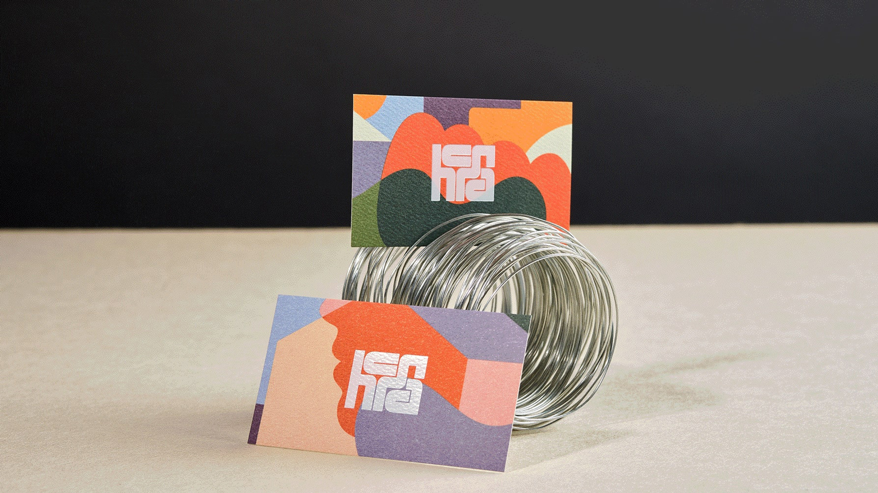 Two HCMA business cards utilizing different patterns of organic/colourful shapes each time.
