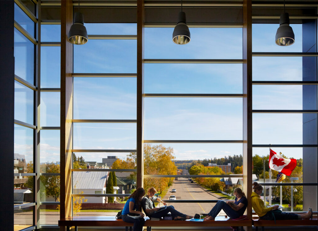 Student siting in front of a large window