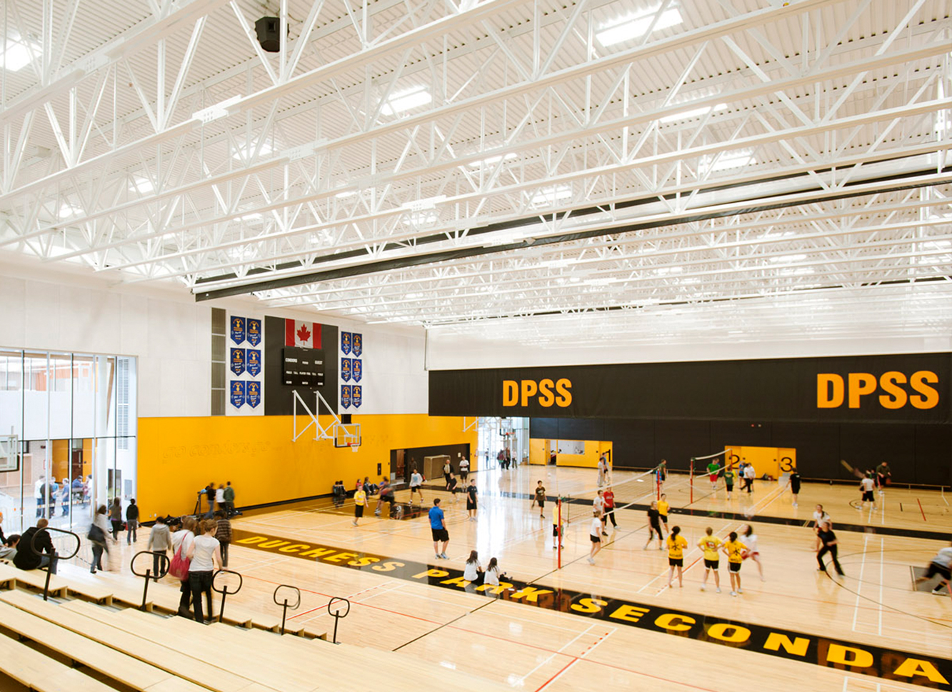 People playing volleyball in a gymnasium 