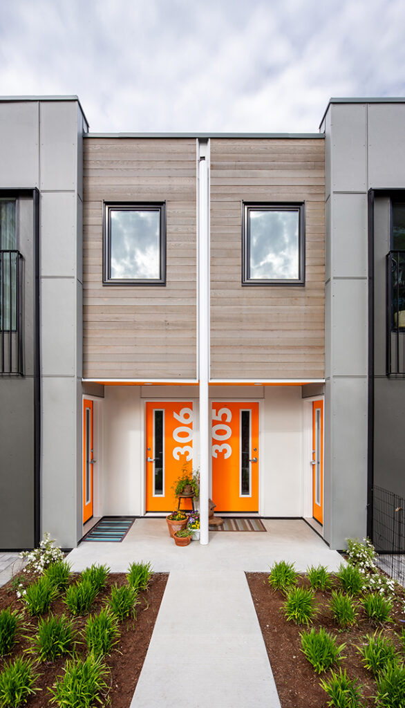 Two bright orange doors with numbers on them.