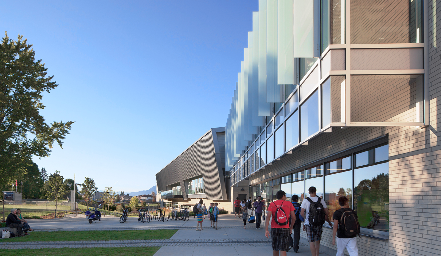Exterior shot of Hillcrest Centre as viewed from the side, with people walking along the pathway.