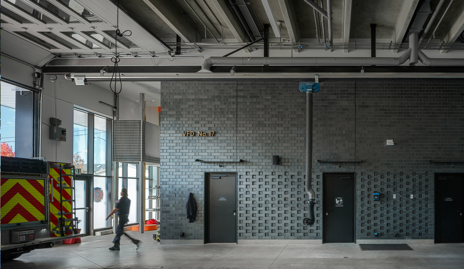 Interior shot of the apparatus bay at Vancouver Fire Hall No. 17, featuring textured brick work.