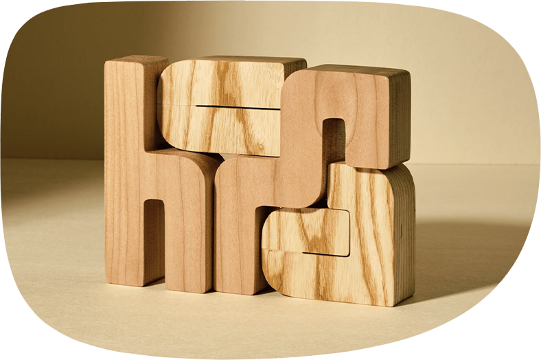 Wood cut hcma logo made from different types of wood.