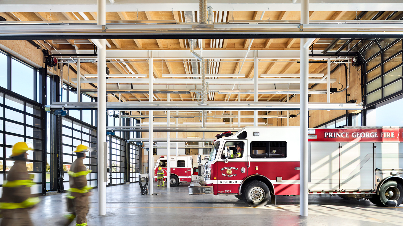 Inside garage of firehall with wooden ceilings and a firetruck