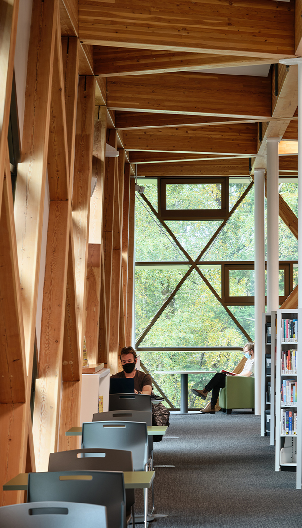 Inside of the library which showcases a geometric pattern made from wooden beams.