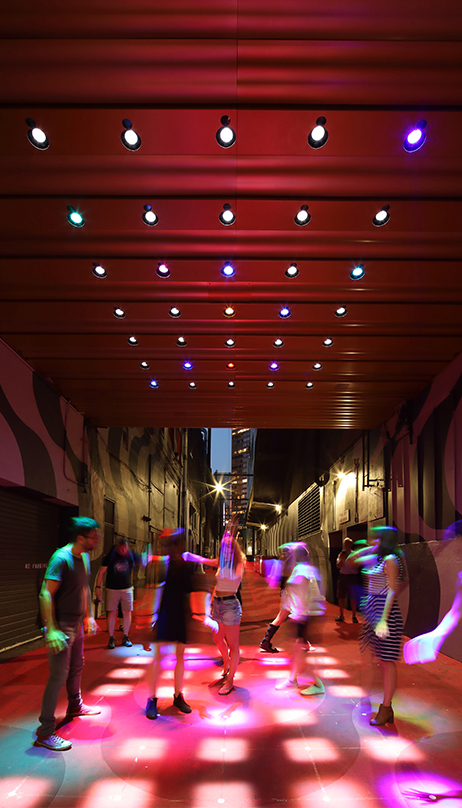 People dancing with the interactive light display at Ackery's Alley