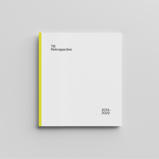 Mock-up of the cover of the Tilt Retrospective on a light grey background.