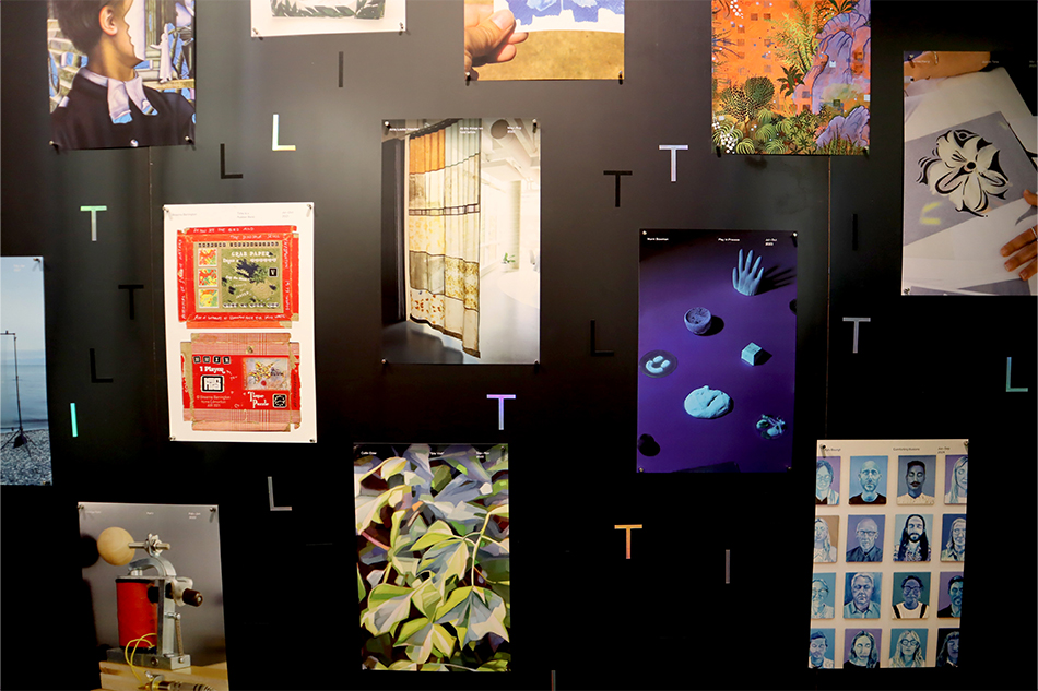 A wall-pin up with images from various Tilt residencies, with iridescent T, I, and L magnets interspersed throughout.